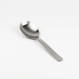 Stainless steel spoon on a white background