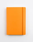 Orange notebook on a light gray background