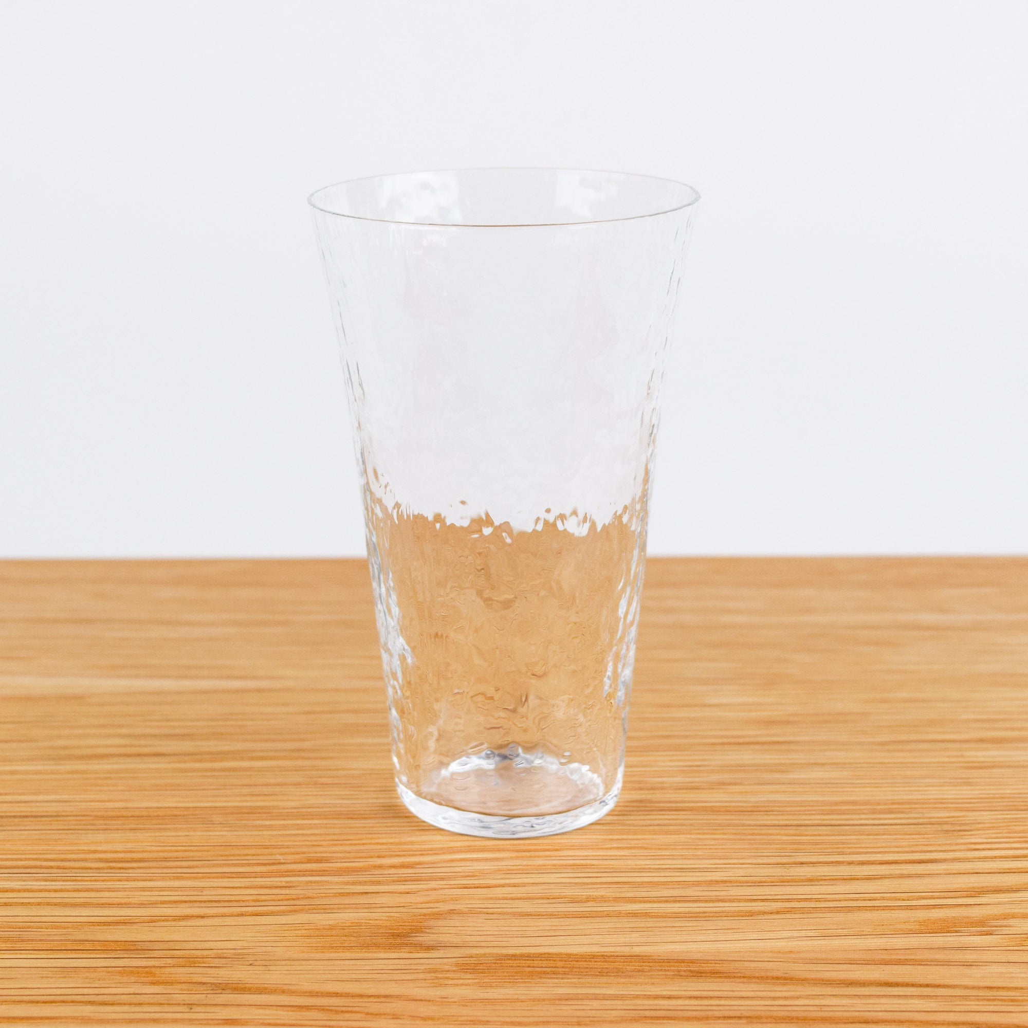 Clear glass on a wooden surface with a white background