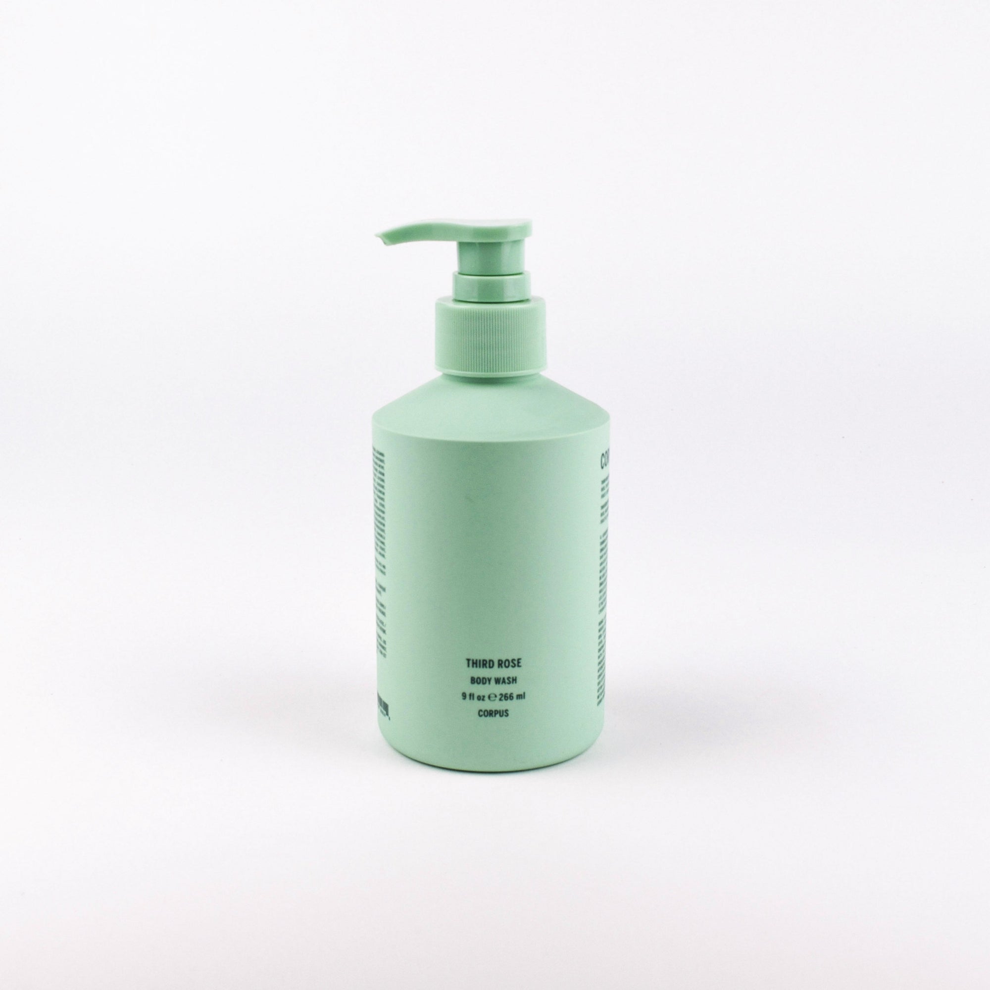 A mint green pump bottle of Third Rose hair shampoo, photographed against a seamless white studio background.