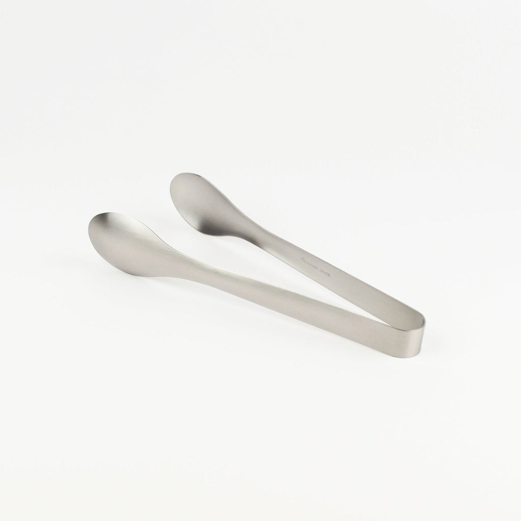 Metallic tongs on a white background