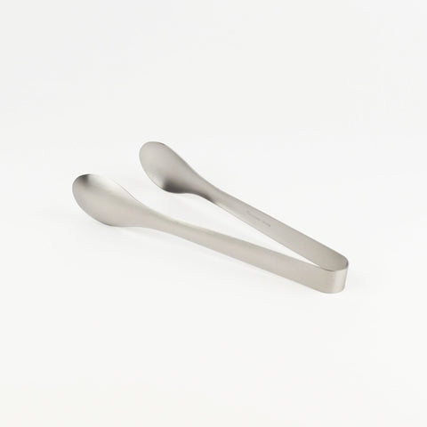 Metallic tongs on a white background