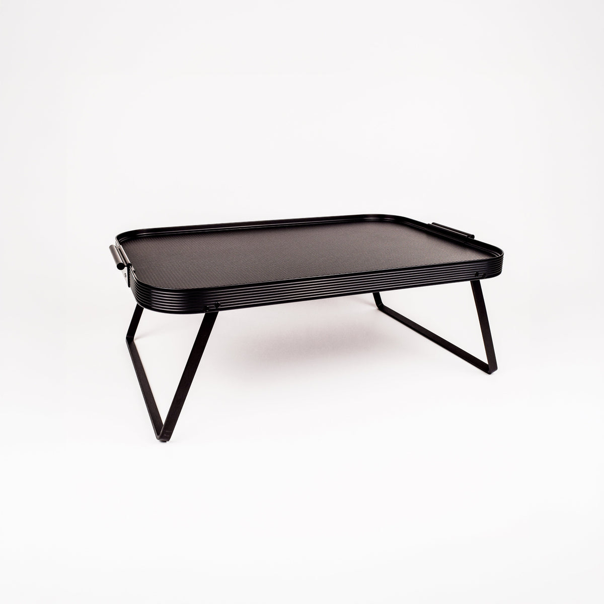 A black rectangular folding table with a textured top surface and slim angled metal legs, shown on a clean white background.