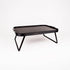 A black rectangular folding table with a textured top surface and slim angled metal legs, shown on a clean white background.