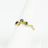 Gold ring with embedded stones on a white background