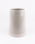 Pale grey ceramic vase on a white background