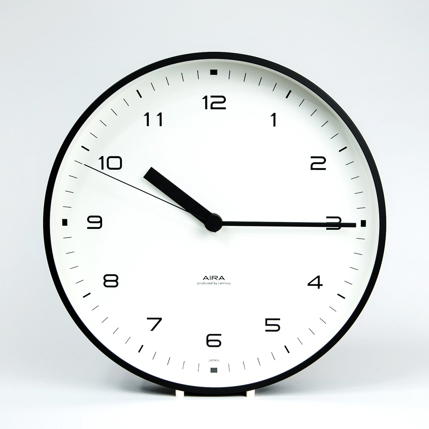 aira clock white dial black metal case