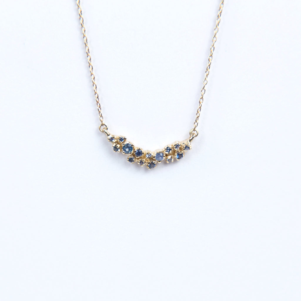 N + A Jewelry: Curved Cluster Blue Sapphire Necklace
