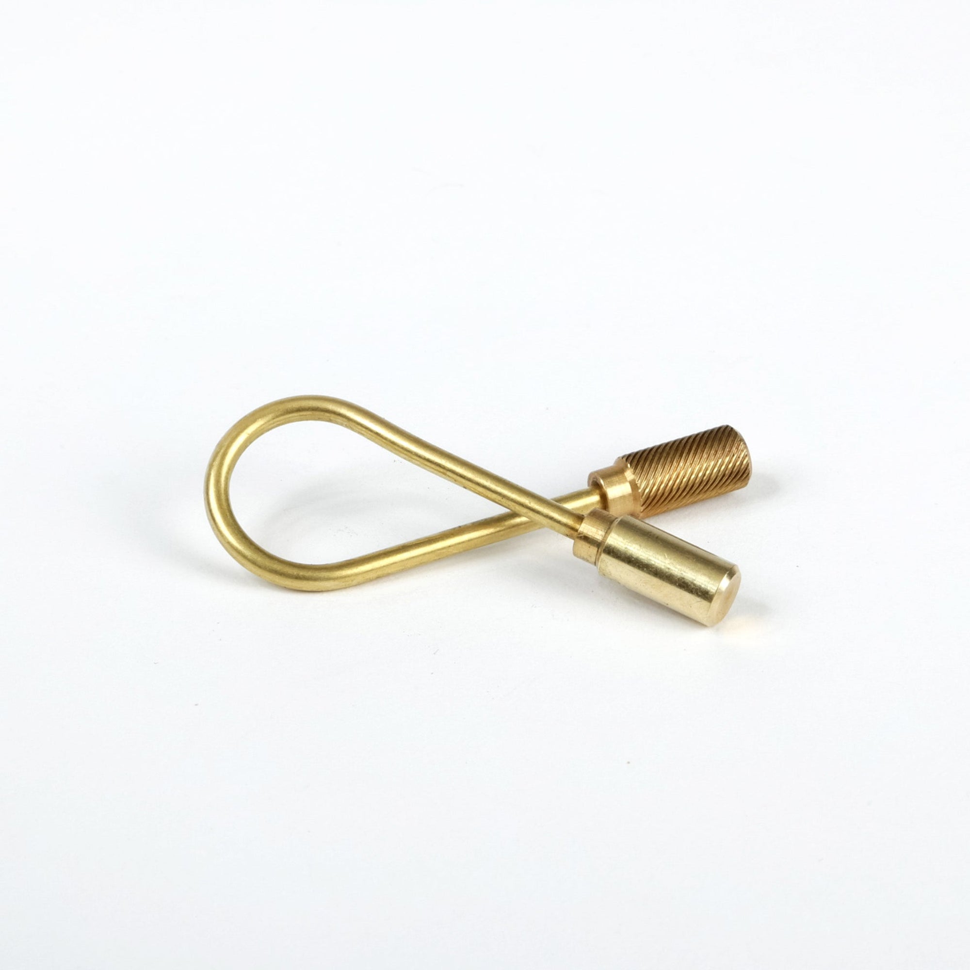 A brass key ring with a helix shape and turned brass end caps on a white background.